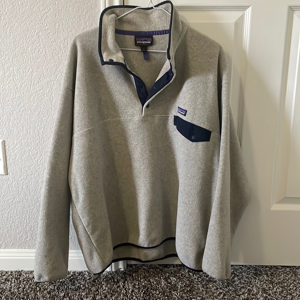 Large gray synchilla Patagonia fleece with navy piping.
